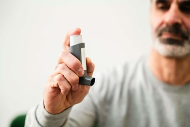 man holding an inhaler